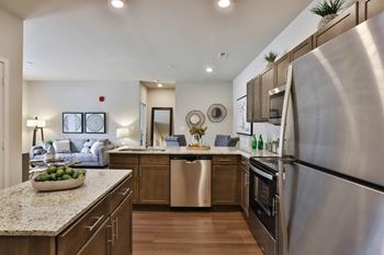 a kitchen with stainless steel appliances and granite counter tops  at Aventura at Hawk Ridge, Missouri, 63367